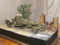 Link to photos of a diorama with a plastic model of the Kanone 18 German heavy gun standing on a crossroads in Berlin arter WW2.