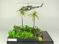 Diorama featuring a damaged M113 armored personnel carrier towing by an elephant and the Bell UH-1B helicopter flying over them - photo No. 1