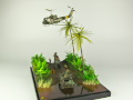 Diorama featuring a damaged M113 armored personnel carrier towing by an elephant and the Bell UH-1B helicopter flying over them - photo No. 2