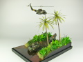 Diorama featuring a damaged M113 armored personnel carrier towing by an elephant and the Bell UH-1B helicopter flying over them - photo No. 3