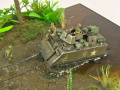 Diorama featuring a damaged M113 armored personnel carrier towing by an elephant and the Bell UH-1B helicopter flying over them - photo No. 10