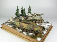 Photos shows the Ardennes Offensive 1944 diorama being made in scale 1:35. The diorama includes two plastic models of German vehicles: Grille Ausf. H and Sd.Kfz. 251 Ausf.D.