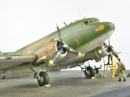 The photos show a scale plastic model of the American AC-47 Spooky air support aircraft from the Vietnam War period.