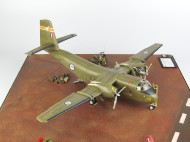 The photos show a scale plastic model of the C-7A Caribou cargo airplane.